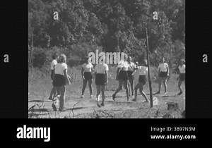 NEW JERSEY - 1940 - Girls at a gbb summer camp play volleyball and must pause to re-inflate the ball Stock Video Footage - Alamy