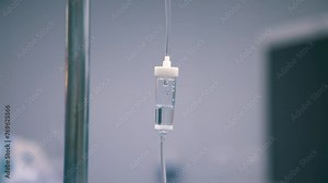 Close-up of the infusion process. A drop of saline is dropped for intravenous infusion.