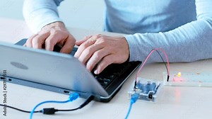 Hardware development. Smart house. IT engineer programming microcontroller board.