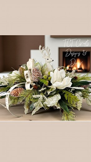 Bring the beauty of a snowy woodland into your home with this Rustic Woodlands Winter Holiday Deer Centerpiece. Handcrafted in a natural wooden Paulownia tray, this elegant design features a standing glittered white deer, snowy magnolias, frosted pinecones, and mixed cedar and pine greenery accented with iced green berries and glittered magnolia and laurel leaves. A soft Farrisilk birch bark ribbon completes the design with a refined, rustic touch. Perfect for your holiday table, mantel, or entr