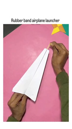 Lazy Legend on Instagram: "This post demonstrates a simple DIY rubber band launcher propelling paper airplanes, converting elastic potential energy to kinetic energy for flights reaching several meters, as evidenced by user reports of 3-meter glides. Replies highlight nostalgic appeal, with users recalling childhood experiments, underscoring the device's role in fostering early interest in aerodynamics and hands-on STEM education. The concept echoes viral tutorials from 2022 onward emphasizing a