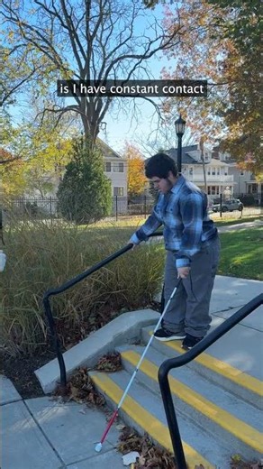 Going down the stairs with a white cane