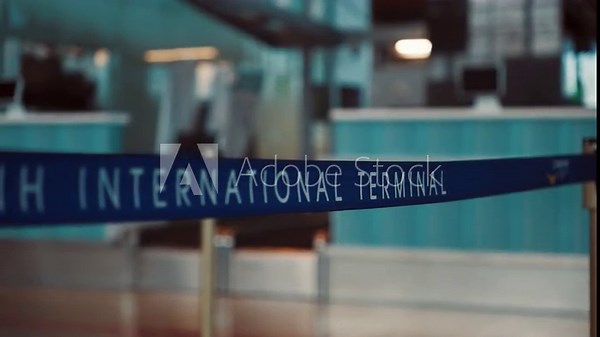 Sign marking the British International Terminal at an airport location with a check-in area visible in the background