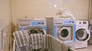 industrial washing machine hotel laundry service laundry dryer concept of cleanliness and hospitality laundry twirling in the drum close-up