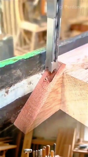 drilling a rectangular hole in a wooden beam using a hollow chisel mortiser for professional joinery