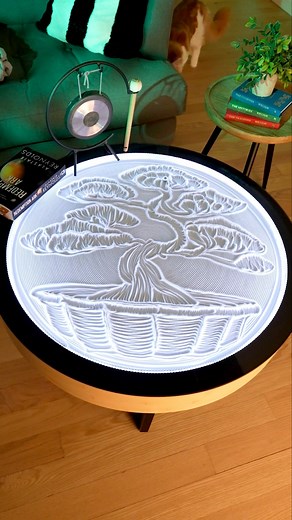 Zen artistry in motion. The Oasis Coffee Table sculpts a delicate Bonsai tree in flowing sand, bringing timeless Eastern tranquility to your living space with every shifting grain. | Grounded Labs