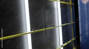 The shop for the production of double-glazed windows and PVC windows, the worker collects a double-glazed window from the windows, for further assembly of the PVC window, close-up