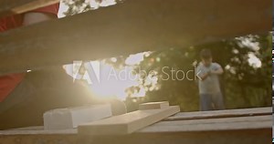 Young male brothers playing a building blocks game on a bench in the park on a sunny afternoon. Having fun together and sharing moments of joy.