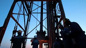 Workers Prepare Drilling Equipment at Sunset in Oil Field Operation | Premium Stock Video Footage