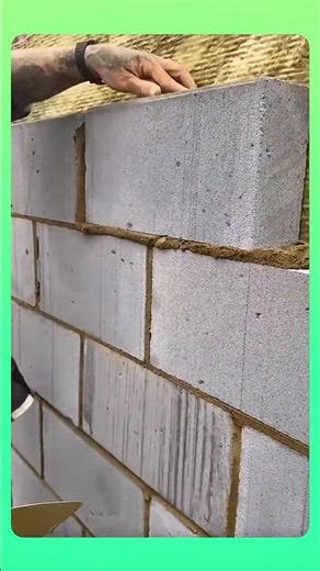 Large concrete blocks arranged neatly, building a strong and even wall structure.#construction