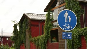 Sign of the pedestrian zone and bike paths on the background of houses