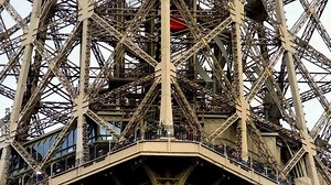 Elevator lift in Eiffel tower in Paris. Famous landmark in France. Popular European travel city & honeymoon destination.