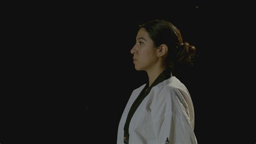 Woman wearing a karate kimono makes a reverence - Free Stock Video