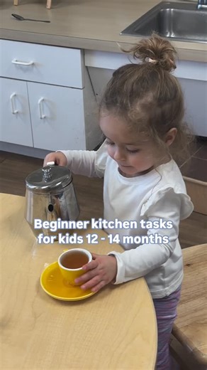 Official Guidepost Montessori on Instagram: "Introducing your child to the kitchen at a young age builds confidence, fine motor skills, and a love for real, purposeful work. At 12–14 months, they’re ready for simple, hands-on tasks that make them feel like a vital part of the family. Here are some great first kitchen activities for your little one: 🥄 Pouring liquid – Using a small pitcher, let them pour water into a cup or bowl. It won’t be perfect, but it’s an important skill to practice! 🍌 P