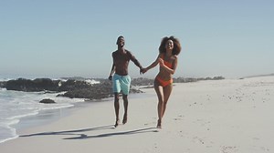 African american couple running side by side at beach Free Stock Video Footage