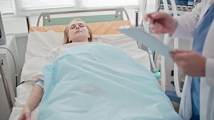 Doctor Examining Unconscious Patient