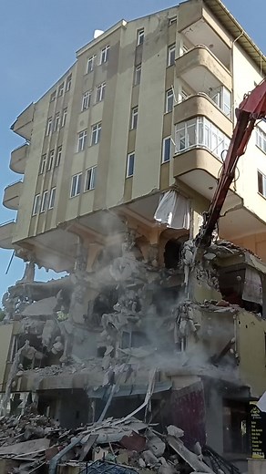 Building Demolition Process with Large Excavator