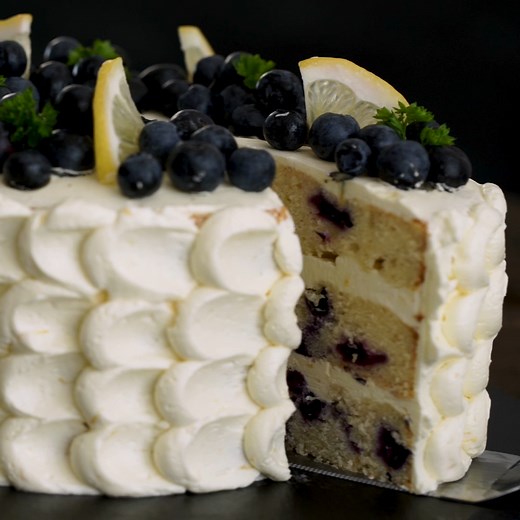 Blueberry Lemon Cake - three layers of blueberry buttery cake bursting with lemon flavor and filled with a delicate lemon swiss meringue buttercream will win your hearts. Full recipe: https://bit.ly/3gWKiDR #blueberrylemoncake | Home Cooking Adventure