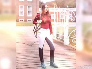 Comely lady dressed in brilliant & thrilling professional riding boots outfit