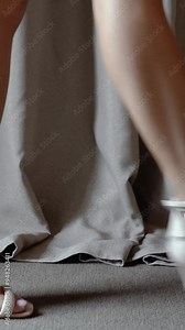 beautiful decorated wedding bouquet of white roses before wedding ceremony. Cute thin beautiful female legs of the bride in high heels close-up