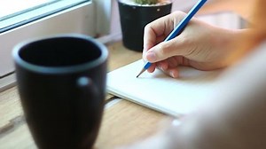 clip-9229034-young-woman-writing-diary