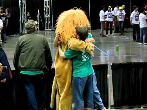 Lion Mascot Hugs Kid in Slow Motion