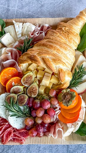 🍂🍁 HARVEST CORNUCOPIA 🍁🍂 after getting lost in a corn maze with five kiddos today, I was grateful for the harvesting of the corn (in the shape of a mermaid 🧜‍♀️). the cornucopia is so often used as a symbol of thanksgiving, and giving thanks for abundance. which makes this side dish perfect for Thanksgiving, but also for any autumn get together! HOW TO MAKE: 🍁 thaw puff pastry and preheat the oven to 400 degrees 🍁 using foil, shape a cone, and curl the tail of the cone upwards 🍁 cut puff