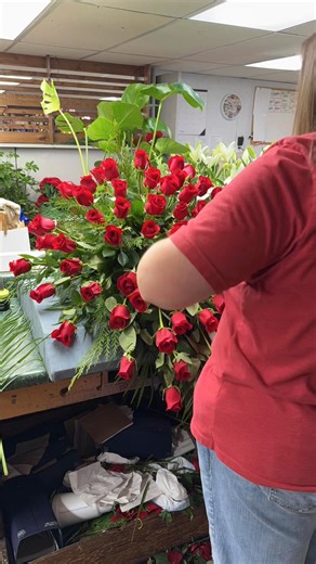 Ashley is designing a solid red rose casket spray with cedar, pine cones and cattails. #jacksonsfloristdexter #florist #floralarrangement #flowershop #casketspray | Jacksons Florist & Gifts