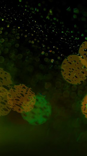 Colorful rain-soaked bokeh lights at night - Free Stock Video