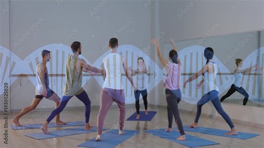Yoga coach cueing and showing poses while class mirroring on mats for posture, mirror reflecting
