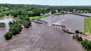 Flooding collapses bridge and threatens 'imminent failure' of dam
