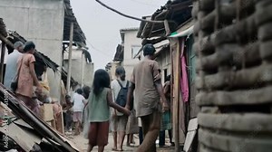 Hunger and poverty affecting adults and children in overcrowded slums surrounded by unclean conditions highlighting silent struggles of survival and inequality