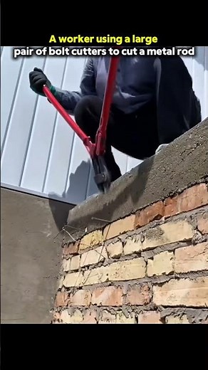 A worker using a large pair of bolt cutters to cut a metal rod or piece of rebar