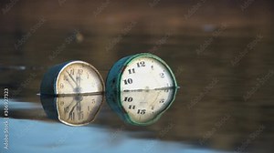 Old rusty clock in water.Retro clock.Rust destroys it.Old non-working retro clock