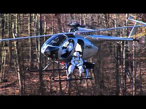 Electric linemen fly in by helicopter to fix live transmission lines