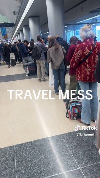 Long lines as people wait to rebook their flights because of cancellations