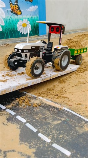 Rc Eicher tractor pulling loaded trolley on off roading track