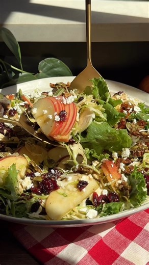 Bright, crunchy, and satisfying, this apple pecan salad combines crisp apples, shaved Brussels, greens, tart cranberries, feta, and a sweet-salty nut-and-seed brittle with an easy balsamic vinaigrette! | Crowded Kitchen