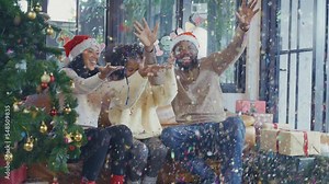A joyful African American family celebrates Christmas Day at home with a Christmas tree, gift-giving, celebration, and a reunion of the family.