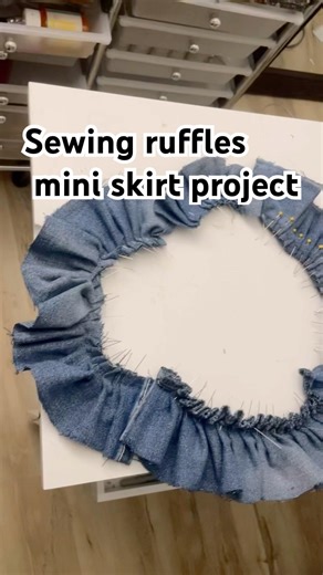 Sewing ruffles for my blue jean mini skirt project.