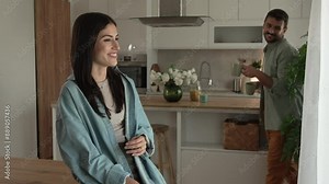Boyfriend and girlfriend enjoy their first morning coffee at kitchen