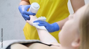 Depilation of hair on the girl's body using wax application. Body sugaring procedure