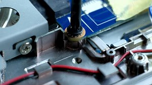 Close up. Man Repairing Motherboard from PC. Repair Shop. Worker with Tools. Computer Hardware. Digital Device. Laptop on Desk. Electronic Devices Concept.