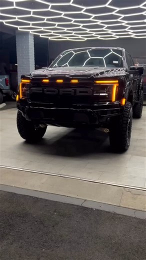 Ken Grody Ford on Instagram: "AVAILABLE NOW — BUT NOT FOR LONG. This Agate Black 2025 Raptor is a full KG Custom build and it goes hard 🇺🇸 Here’s what you’re looking at: • LVLD front coil spring level lift • 20” Vossen wheels • Black spline drive locking lugs • 37” Nitto Ridge Grapplers • Paint-matched bumpers, flares + dove tails • 3M anti-chip clear bra (front bumper) • Amp Research power deployable boards • Reviver digital license plate Looks mean. Drives meaner. If you’ve been waiting for