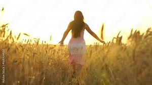 pretty girl in the dress is running across the field.