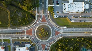 Road roundabout intersection with fast moving heavy traffic. Timelapse of urban circular transportation crossroads