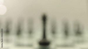 change of focus from the black king to the black chess pieces on the chessboard