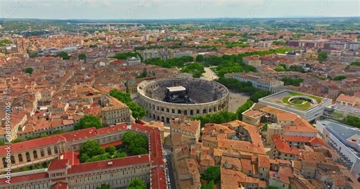 Aerial view of Nimes city with Roman amphitheater, travel in Nimes, France. Nimes Arena aerial panoramic view. Nimes is a city in the Occitanie region of southern France