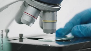 Microscope in the laboratory close-up. A scientist using a high-tech microscope examines a sample in an industrial laboratory. Science and technology. Tests. Medical experiment.