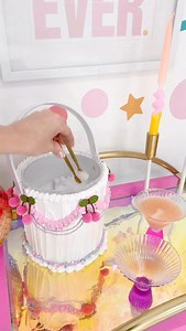 The cutest fake cake ice bucket for your bar cart! I used a two piece plastic ice bucket, covered the outside in DAP light weight spackle, and added faux sprinkles and pom pom cherries. | Kailo Chic